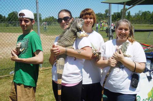 Brandon Torbic, Christina Gable, Kyle Bailey and Trixie Bailey show off four exotic reptiles at the June's Angel's Relay for Life fundraiser event on June 7